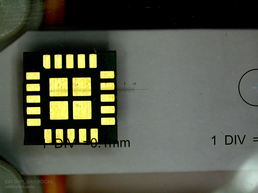 One of the calibration slides, with the 1-mm-per-division scale above a surface-mount CO2 sensor.