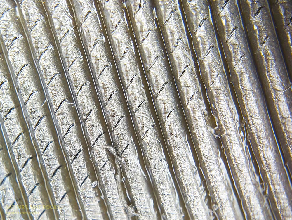 Another zoomy picture of the file, taken near the tang end showing the start of the The surface of the flat side of the file, after I'd put it to use but before I'd cleaned off the stainless steel crumbs.