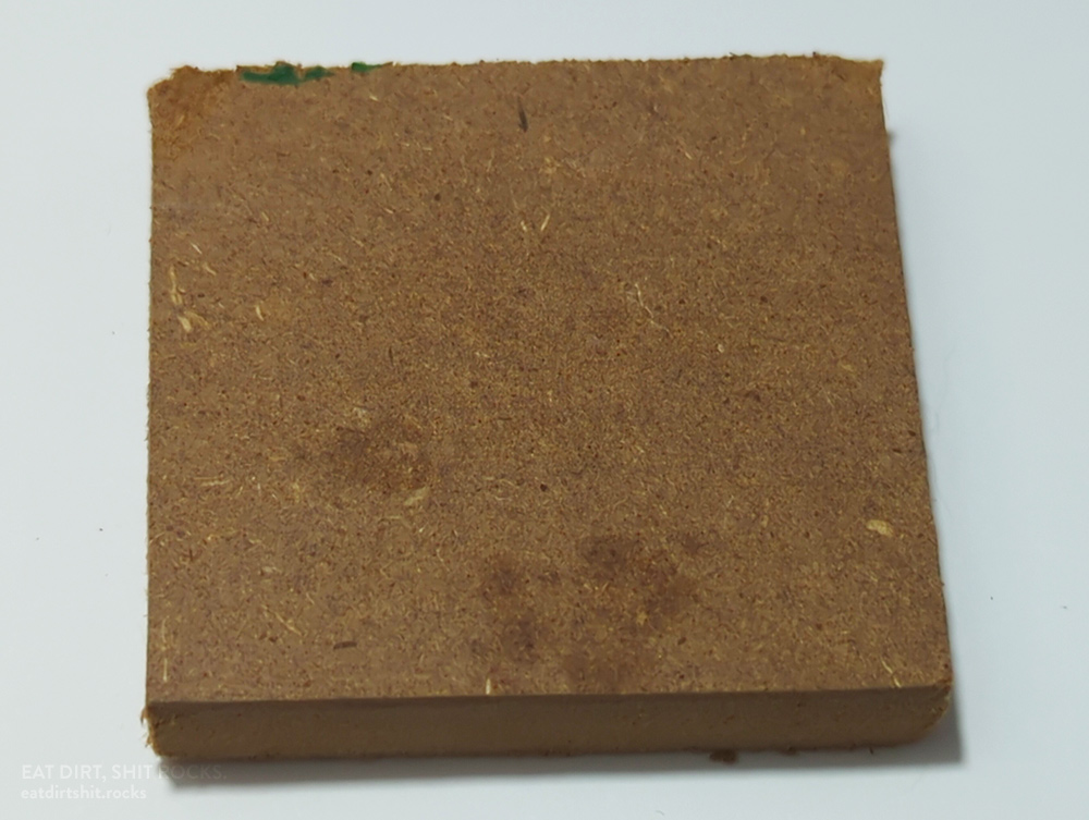 A roughly 4.5cm-square-ish sample of the fiberboard I used.
