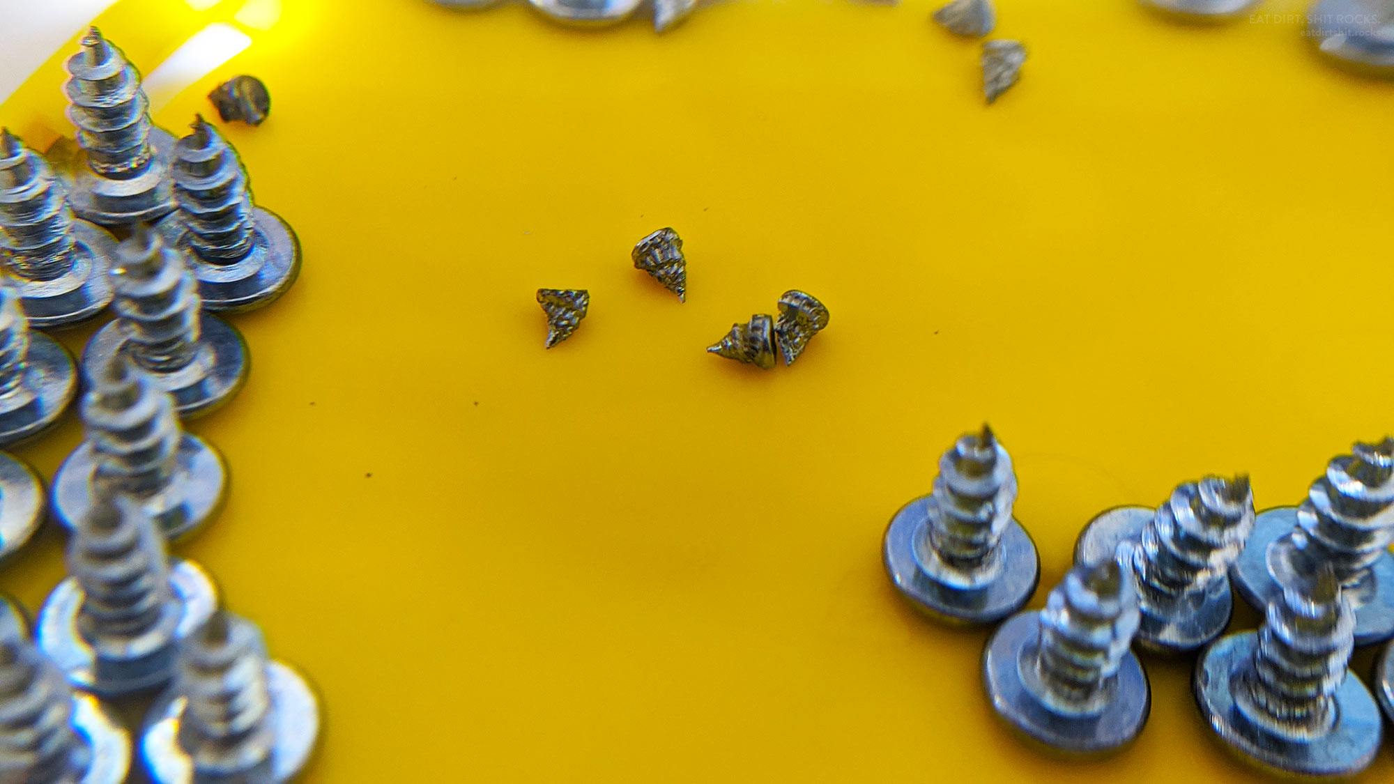 Check out the metal scraps that I suspect are swarf from the thread-cutting step in the manufacture of these screws.